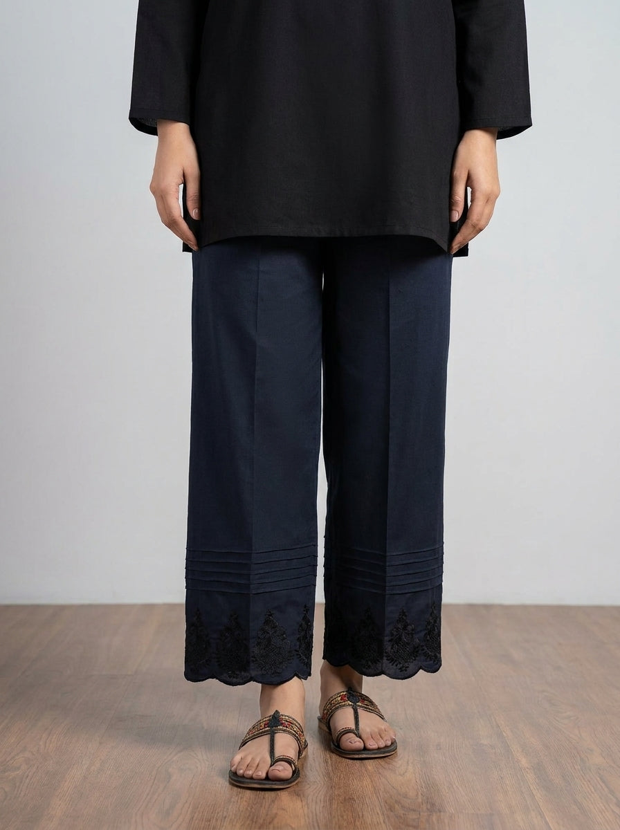 Black cotton straight trouser with pin-tucks and embroidered scalloped hem