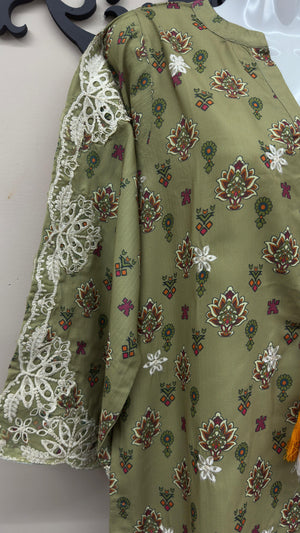 Close-up of white embroidered lace sleeves on olive green Pakistani dress