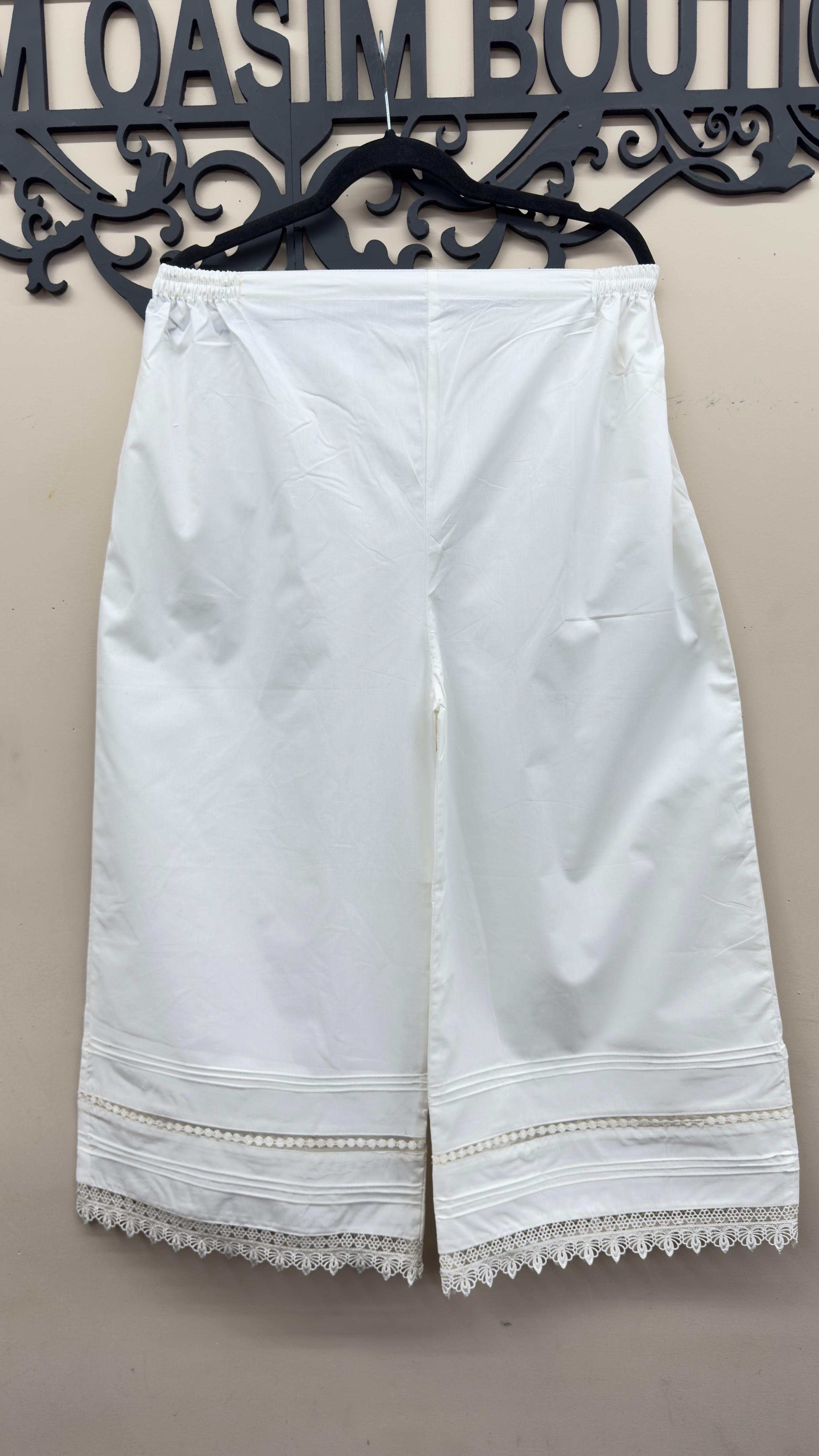 Off-white Khaadi embroidered cotton trousers styled for Indian and Pakistani women's dresses.