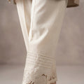 Off-white cotton straight trouser featuring floral cutwork embroidery along the bottom hem.