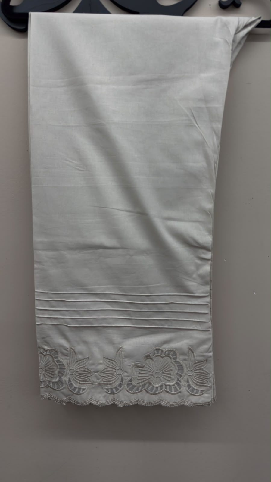 Off-white cutwork embroidered cotton pants styled for Pakistani and Indian women's dresses.