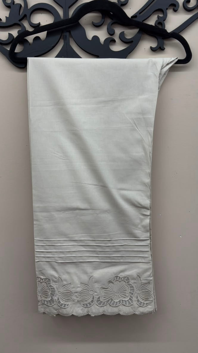 Off-white cutwork embroidered cotton pants styled for Pakistani and Indian women's dresses.
