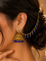 Traditional gold jhumka earrings with royal blue beads and matching sahara chain for bridal and festive wear.