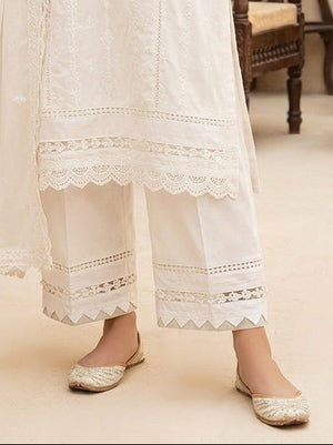 dual lace inlays and geometric triangle cutwork on Khaadi off-white trousers