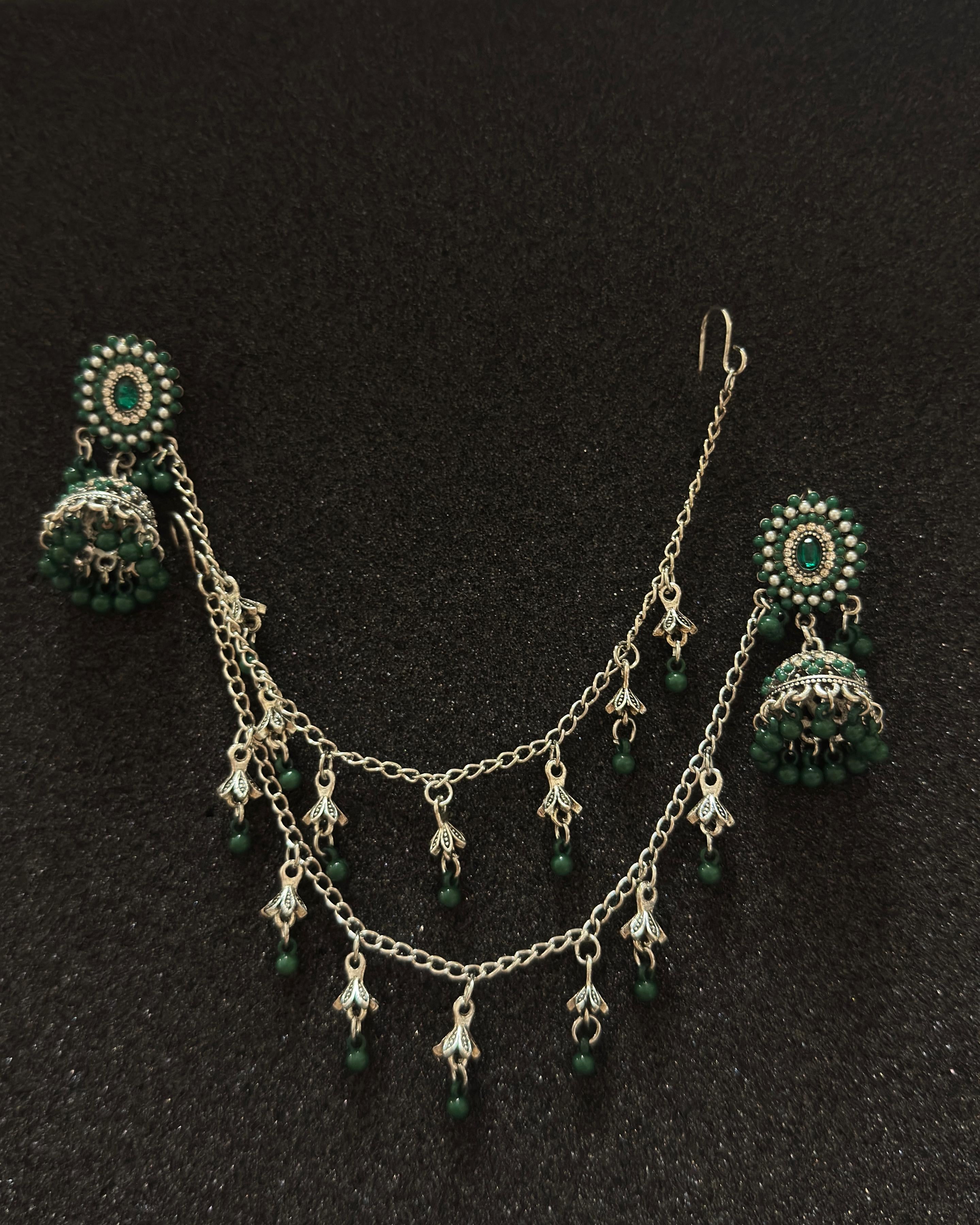 Oxidized silver jhumka earrings with emerald green stones and decorative sahara chain in Canada
