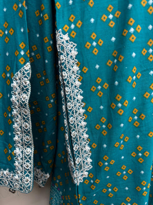 Teal fabric with white and gold patterns and lace trim